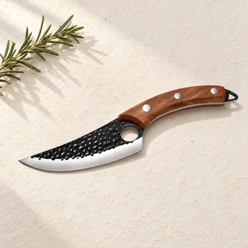 The Kiba Knife with hammered blade and riveted wood handle on cream washi paper
